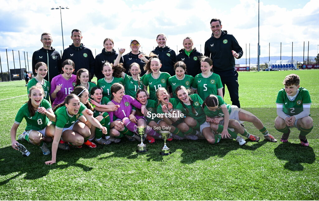 17 April 2025; Republic of Ireland players and coaches celebrate with the Bob Docherty Cup after their side's victory in the Girls U15 SAFIB Bob Docherty Cup match between Northern Ireland and Republic of Ireland at Greenisland FC in Antrim. Photo by Seb Daly/Sportsfile