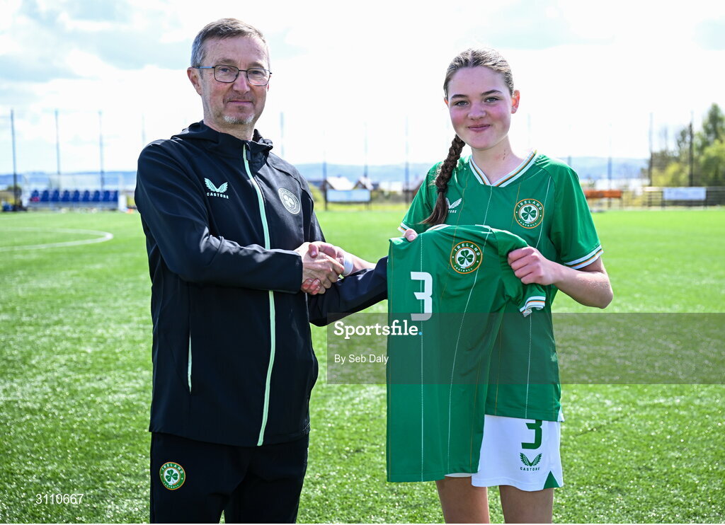 17 April 2025; Ava Hallinan of Republic of Ireland is presented with her jersey by Republic of Ireland head coach Richard Berkeley after the Girls U15 SAFIB Bob Docherty Cup match between Northern Ireland and Republic of Ireland at Greenisland FC in Antrim. Photo by Seb Daly/Sportsfile