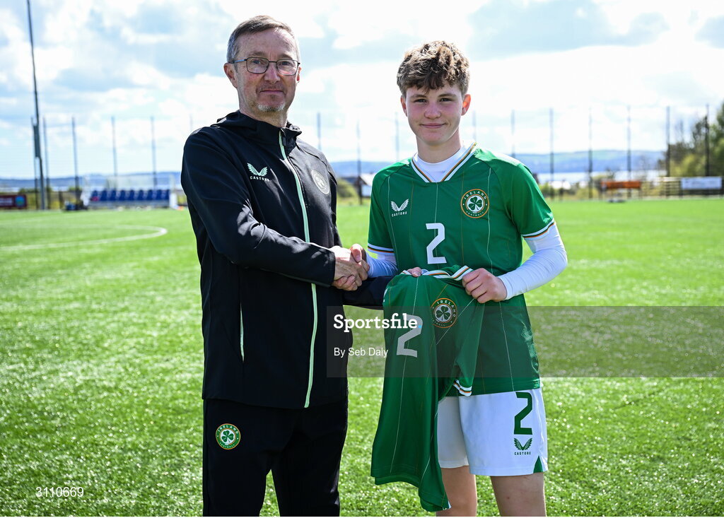 17 April 2025; Leah O’Leary Callender of Republic of Ireland is presented with her jersey by Republic of Ireland head coach Richard Berkeley after the Girls U15 SAFIB Bob Docherty Cup match between Northern Ireland and Republic of Ireland at Greenisland FC in Antrim. Photo by Seb Daly/Sportsfile