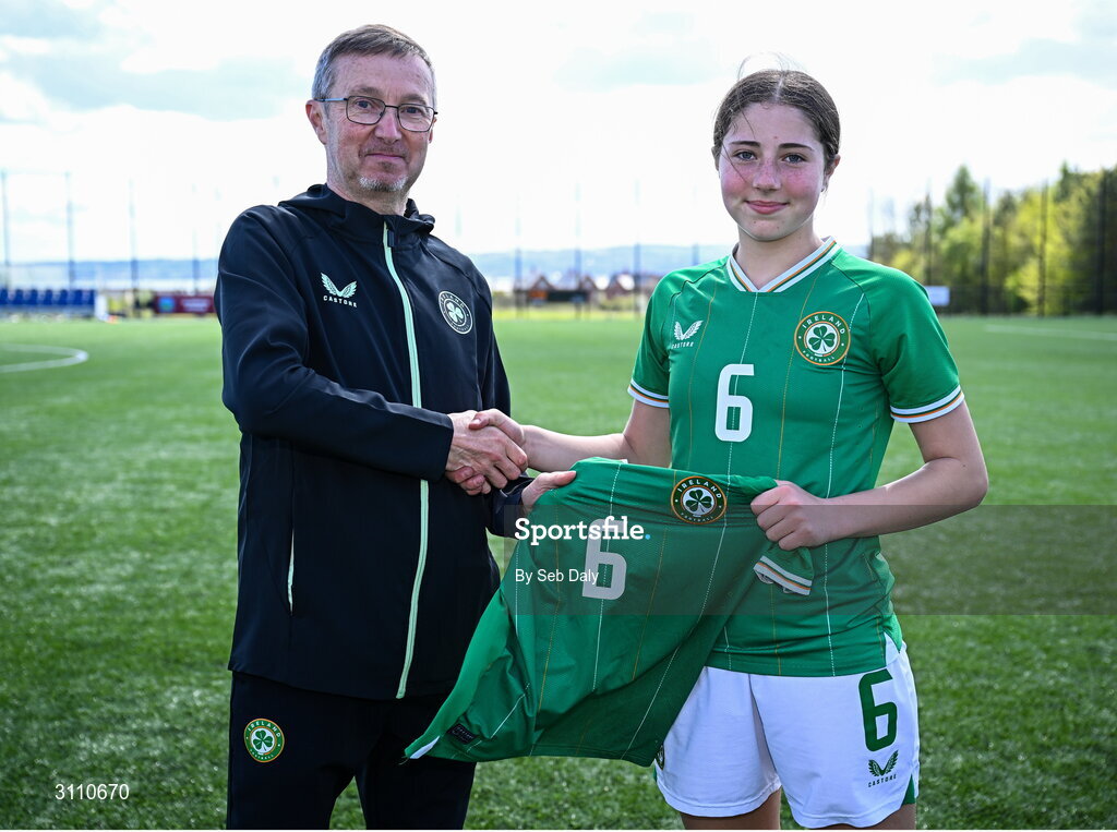 17 April 2025; Lara Dallaghan of Republic of Ireland is presented with her jersey by Republic of Ireland head coach Richard Berkeley after the Girls U15 SAFIB Bob Docherty Cup match between Northern Ireland and Republic of Ireland at Greenisland FC in Antrim. Photo by Seb Daly/Sportsfile