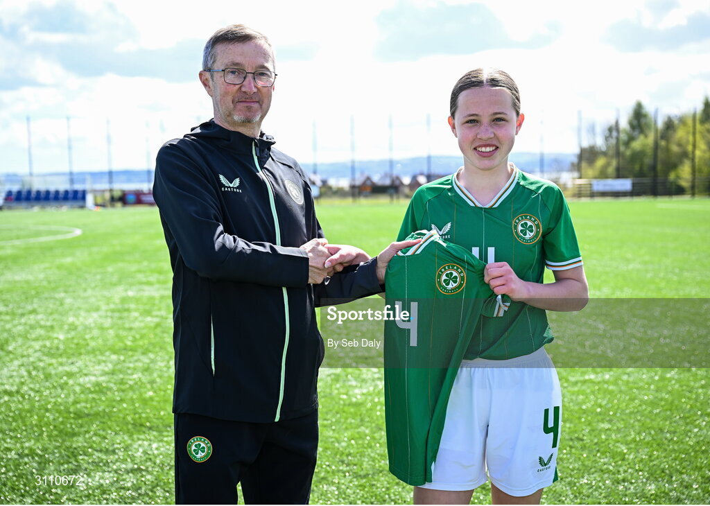 17 April 2025; Skye Barrett of Republic of Ireland is presented with her jersey by Republic of Ireland head coach Richard Berkeley after the Girls U15 SAFIB Bob Docherty Cup match between Northern Ireland and Republic of Ireland at Greenisland FC in Antrim. Photo by Seb Daly/Sportsfile