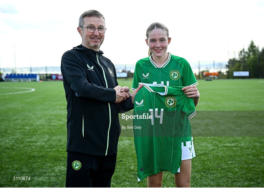 17 April 2025; Hailey Twomey of Republic of Ireland is presented with her jersey by Republic of Ireland head coach Richard Berkeley after the Girls U15 SAFIB Bob Docherty Cup match between Northern Ireland and Republic of Ireland at Greenisland FC in Antrim. Photo by Seb Daly/Sportsfile