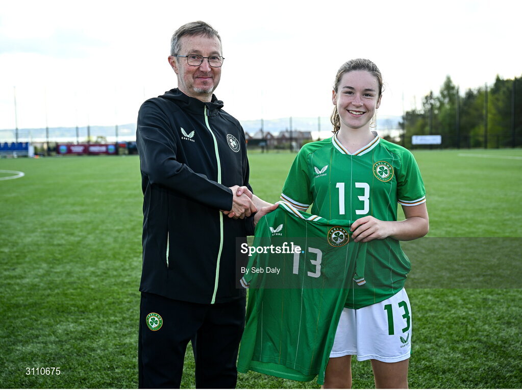 17 April 2025; Maisy Healy of Republic of Ireland is presented with her jersey by Republic of Ireland head coach Richard Berkeley after the Girls U15 SAFIB Bob Docherty Cup match between Northern Ireland and Republic of Ireland at Greenisland FC in Antrim. Photo by Seb Daly/Sportsfile