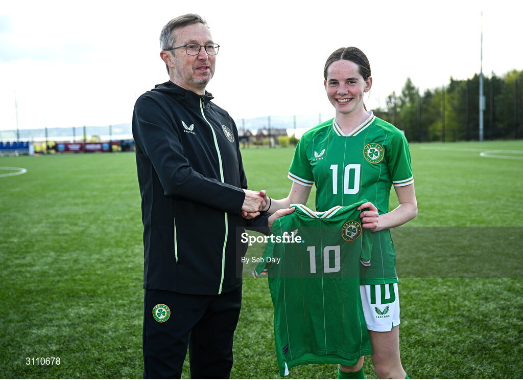 17 April 2025; Ellen Goggin of Republic of Ireland is presented with her jersey by Republic of Ireland head coach Richard Berkeley after the Girls U15 SAFIB Bob Docherty Cup match between Northern Ireland and Republic of Ireland at Greenisland FC in Antrim. Photo by Seb Daly/Sportsfile