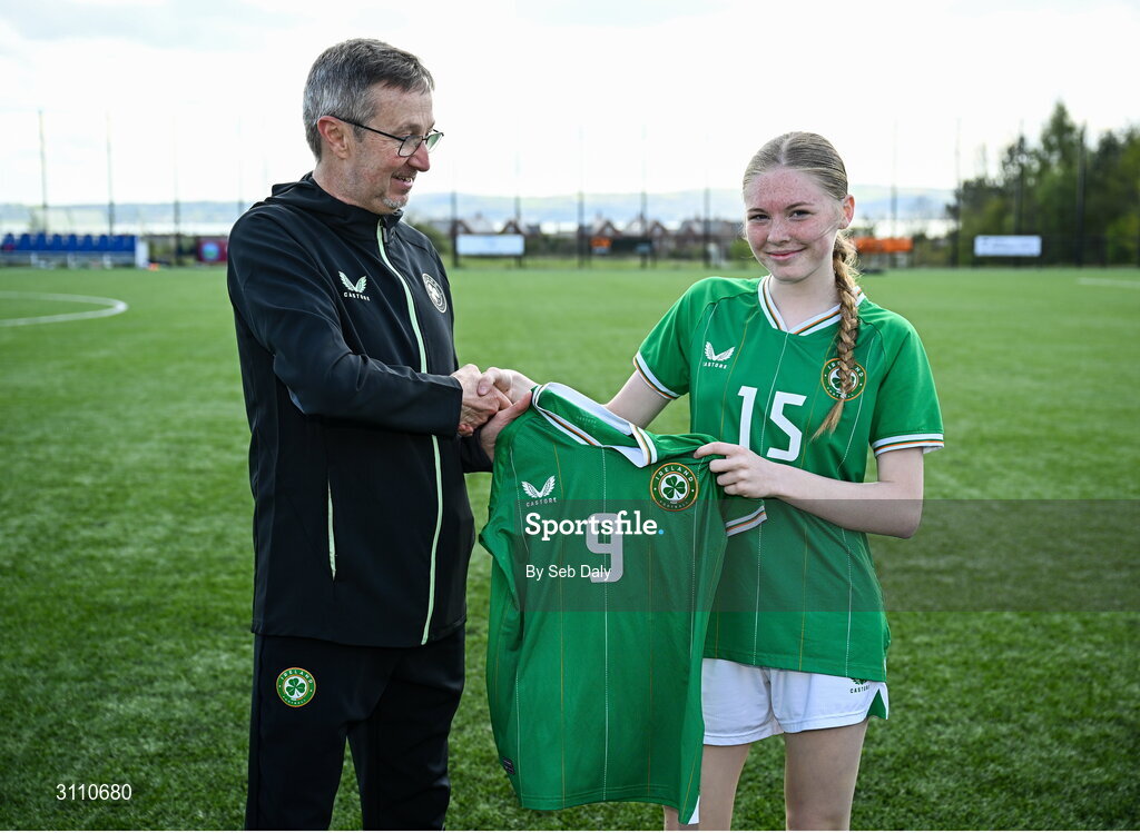 17 April 2025; Ava Kelly of Republic of Ireland is presented with her jersey by Republic of Ireland head coach Richard Berkeley after the Girls U15 SAFIB Bob Docherty Cup match between Northern Ireland and Republic of Ireland at Greenisland FC in Antrim. Photo by Seb Daly/Sportsfile