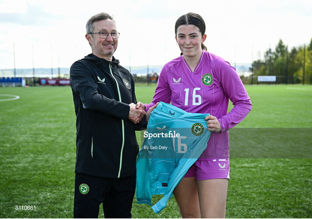 17 April 2025; Republic of Ireland goalkeeper Lucy Doyle Farrington is presented with her jersey by Republic of Ireland head coach Richard Berkeley after the Girls U15 SAFIB Bob Docherty Cup match between Northern Ireland and Republic of Ireland at Greenisland FC in Antrim. Photo by Seb Daly/Sportsfile
