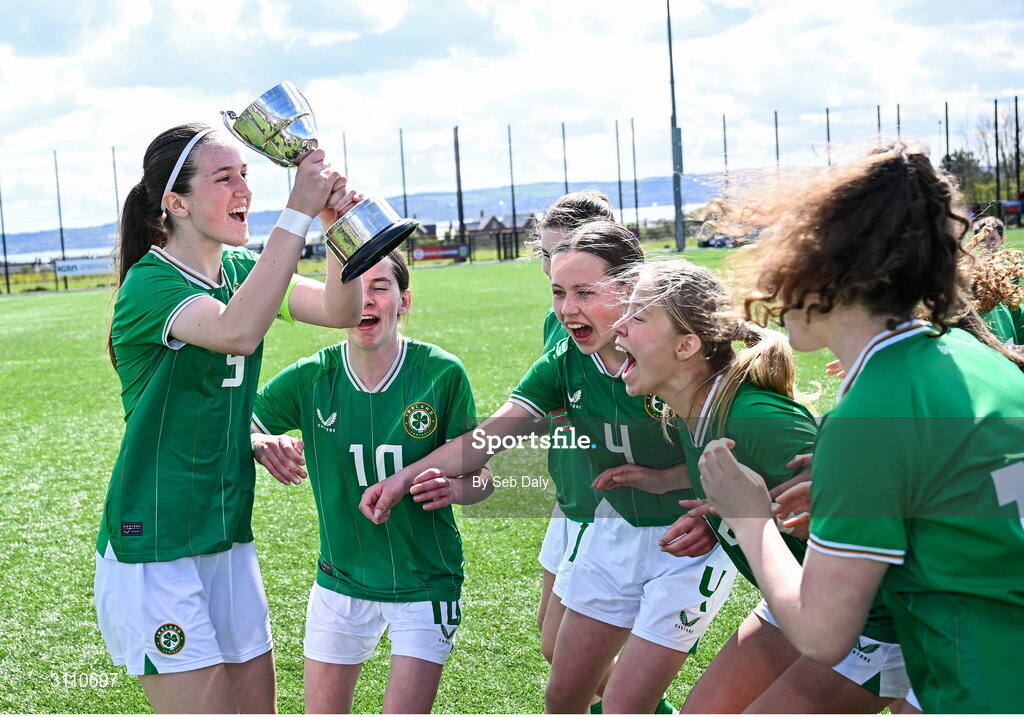 17 April 2025; Republic of Ireland captain Ciara Milton lifts the Bob Docherty Cup alongside teammates after their side's victory in the Girls U15 SAFIB Bob Docherty Cup match between Northern Ireland and Republic of Ireland at Greenisland FC in Antrim. Photo by Seb Daly/Sportsfile