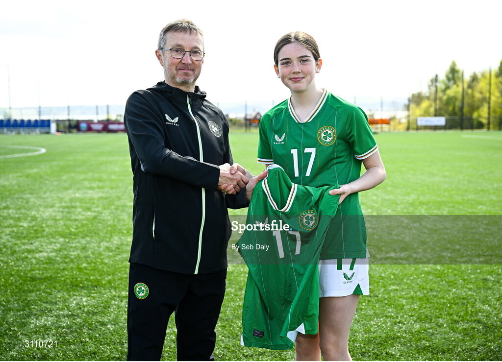 17 April 2025; Kyra Gavigan of Republic of Ireland is presented with her jersey by Republic of Ireland head coach Richard Berkeley after the Girls U15 SAFIB Bob Docherty Cup match between Northern Ireland and Republic of Ireland at Greenisland FC in Antrim. Photo by Seb Daly/Sportsfile