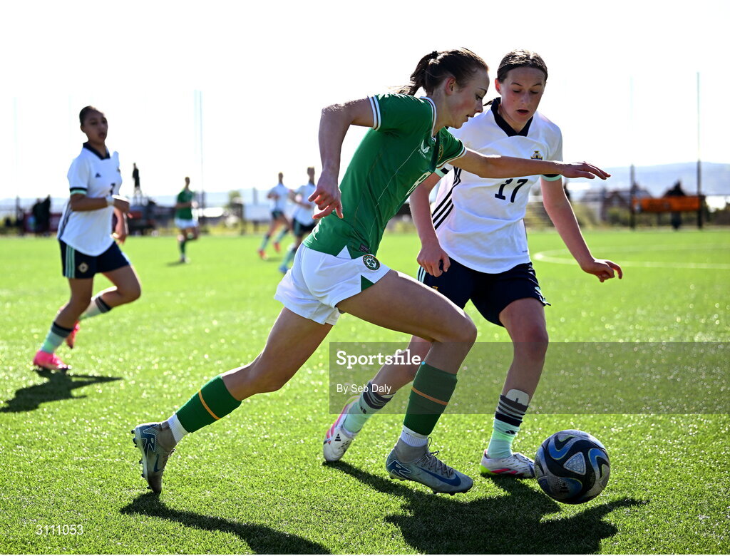 17 April 2025; Ruby Norris of Republic of Ireland in action against Grace Murray of Northern Ireland during the Girls U15 SAFIB Bob Docherty Cup match between Northern Ireland and Republic of Ireland at Greenisland FC in Antrim. Photo by Seb Daly/Sportsfile