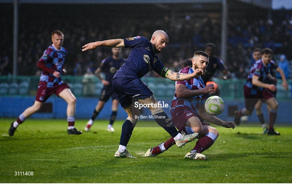 18 April 2025; Mark Coyle of Shelbourne shoots to score his side's first goal despite the efforts of Conor Keeley of Drogheda United during the SSE Airtricity Men's Premier Division match between Drogheda United and Shelbourne at Sullivan & Lambe Park in Drogheda, Louth. Photo by Ben McShane/Sportsfile