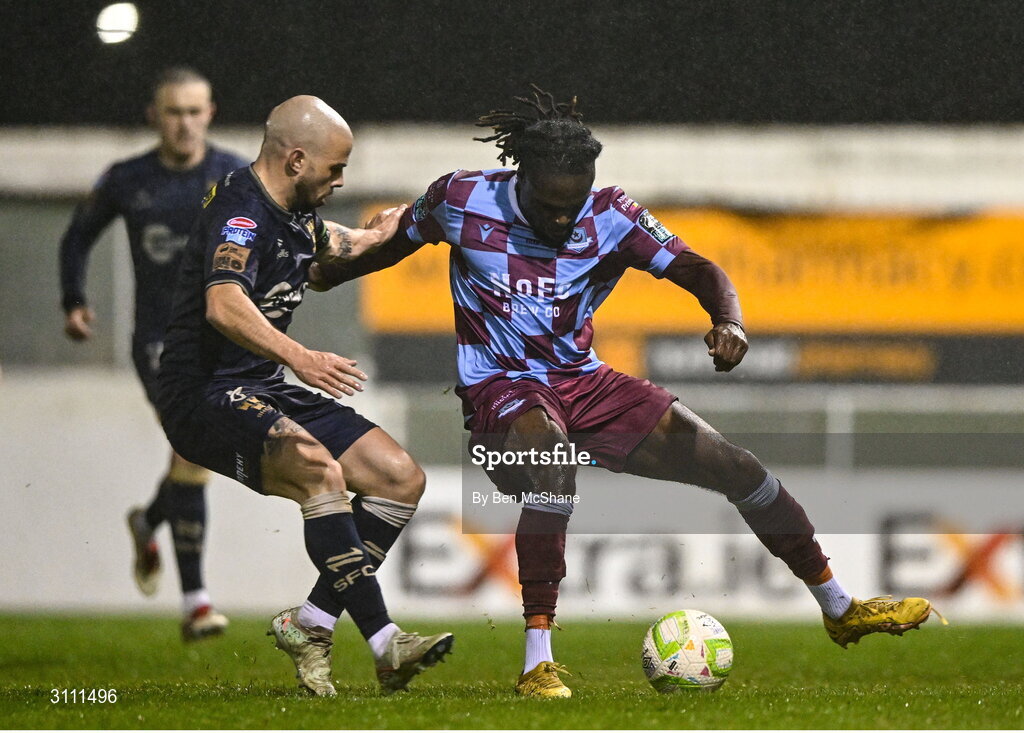 18 April 2025; Thomas Oluwa of Drogheda United in action against Mark Coyle of Shelbourne during the SSE Airtricity Men's Premier Division match between Drogheda United and Shelbourne at Sullivan & Lambe Park in Drogheda, Louth. Photo by Ben McShane/Sportsfile