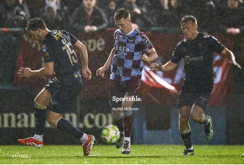 18 April 2025; Warren Davis of Drogheda United in action against Sam Bone, left, and JJ Lunney of Shelbourne during the SSE Airtricity Men's Premier Division match between Drogheda United and Shelbourne at Sullivan & Lambe Park in Drogheda, Louth. Photo by Ben McShane/Sportsfile