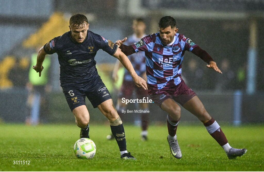 18 April 2025; JJ Lunney of Shelbourne in action against Luke Heeney of Drogheda United during the SSE Airtricity Men's Premier Division match between Drogheda United and Shelbourne at Sullivan & Lambe Park in Drogheda, Louth. Photo by Ben McShane/Sportsfile