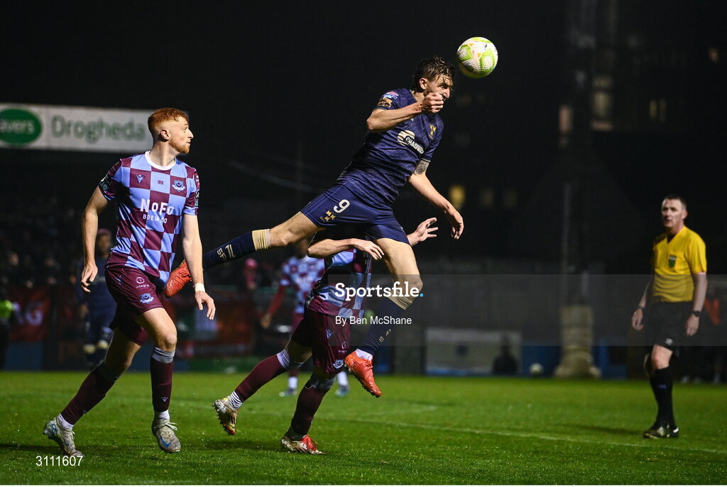 18 April 2025; Sean Boyd of Shelbourne in action against Kieran Cruise, hidden, and James Bolger of Drogheda United during the SSE Airtricity Men's Premier Division match between Drogheda United and Shelbourne at Sullivan & Lambe Park in Drogheda, Louth. Photo by Ben McShane/Sportsfile