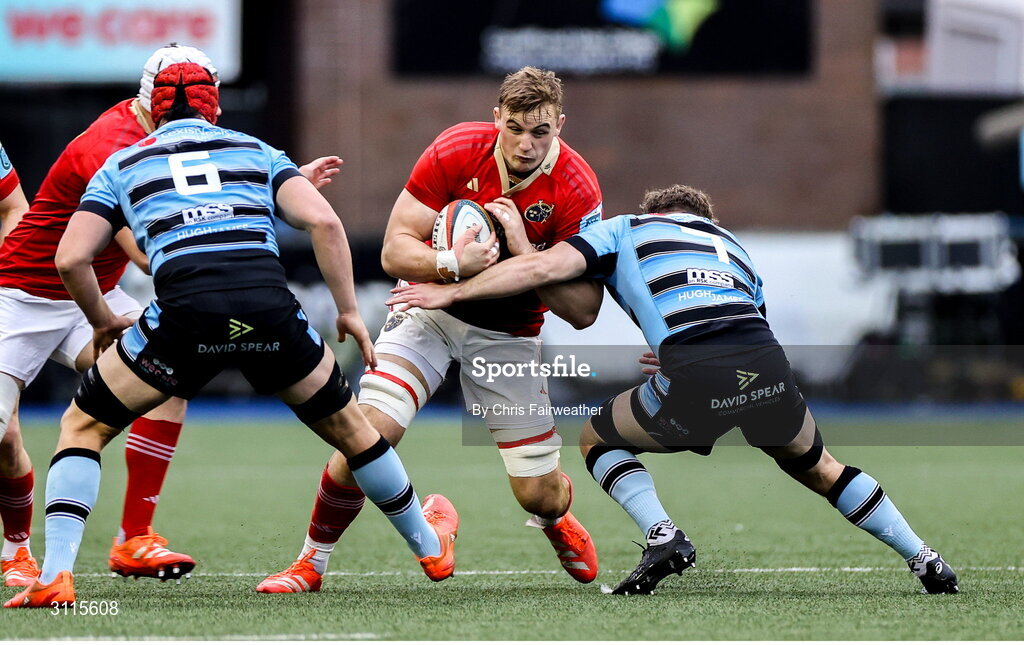 25 April 2025; Gavin Coombes of Munster is tackled by Thomas Young of Cardiff during the United Rugby Championship match between Cardiff and Munster at Cardiff Arms Park in Cardiff, Wales. Photo by Chris Fairweather/Sportsfile