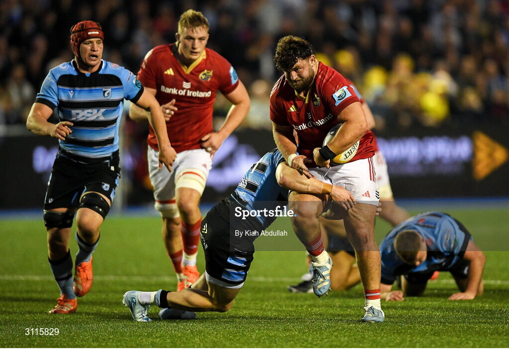 25 April 2025; Michael Milne of Munster is challenged by Kieron Assiratti of Cardiff during the United Rugby Championship match between Cardiff and Munster at Cardiff Arms Park in Cardiff, Wales. Photo by Kian Abdullah/Sportsfile