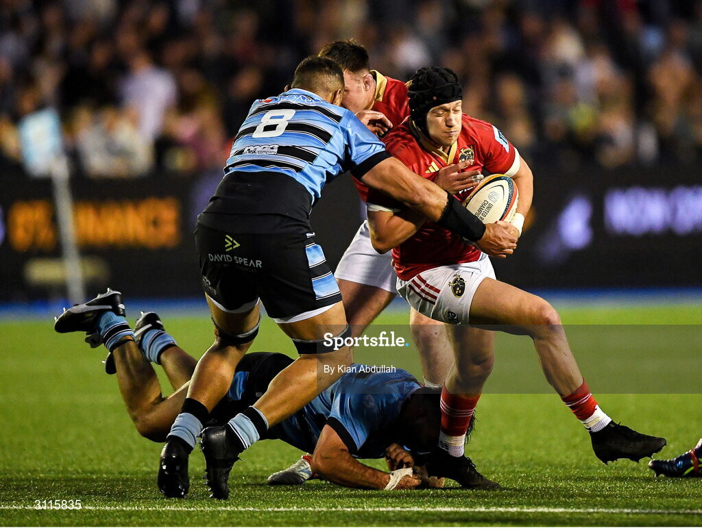 25 April 2025; Mike Haley of Munster is challenged by Taulupe Faletau of Cardiff during the United Rugby Championship match between Cardiff and Munster at Cardiff Arms Park in Cardiff, Wales. Photo by Kian Abdullah/Sportsfile