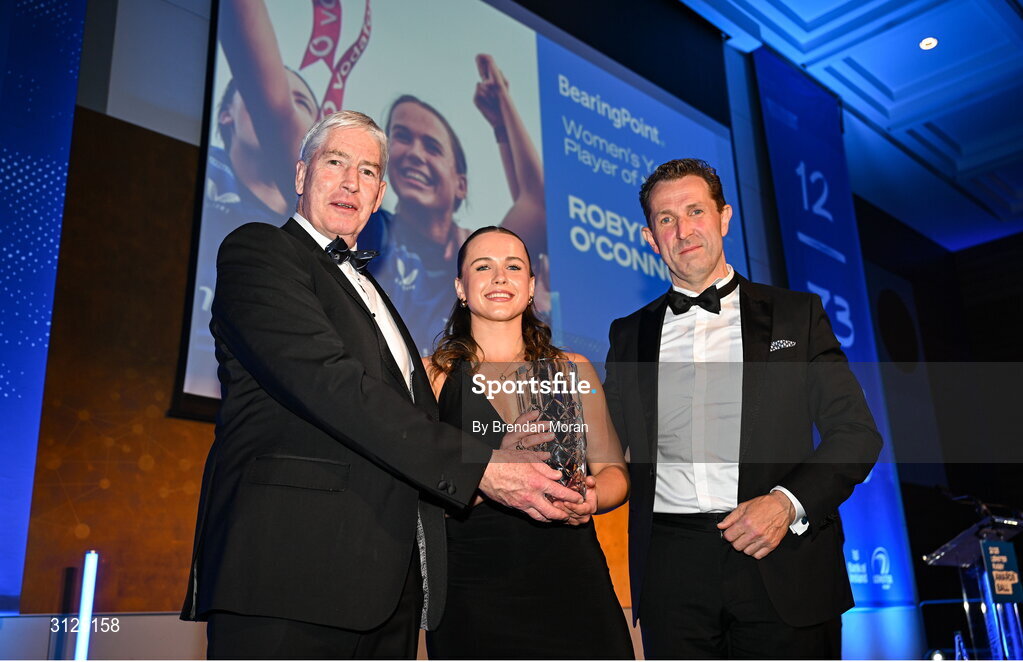 6 May 2025; Robyn O'Connor is presented with the BearingPoint Women’s Young Player of the Year award by Eric Conway, Partner at Bearing Point, right, and Leinster Rugby president Declan Gardiner during the Leinster Rugby awards ball 2025 at O'Reilly Hall in UCD, Dublin. Photo by Brendan Moran/Sportsfile