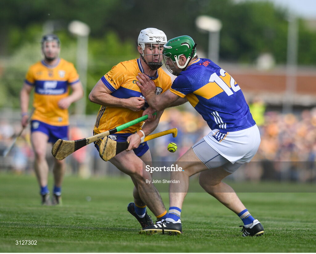 10 May 2025; Daithi Lohan of Clare is tackled by Noel McGrath of Tipperary during the Munster GAA Hurling Senior Championship Round 3 match between Clare and Tipperary at Zimmer Biomet Páirc Chíosóg in Ennis, Clare. Photo by John Sheridan/Sportsfile