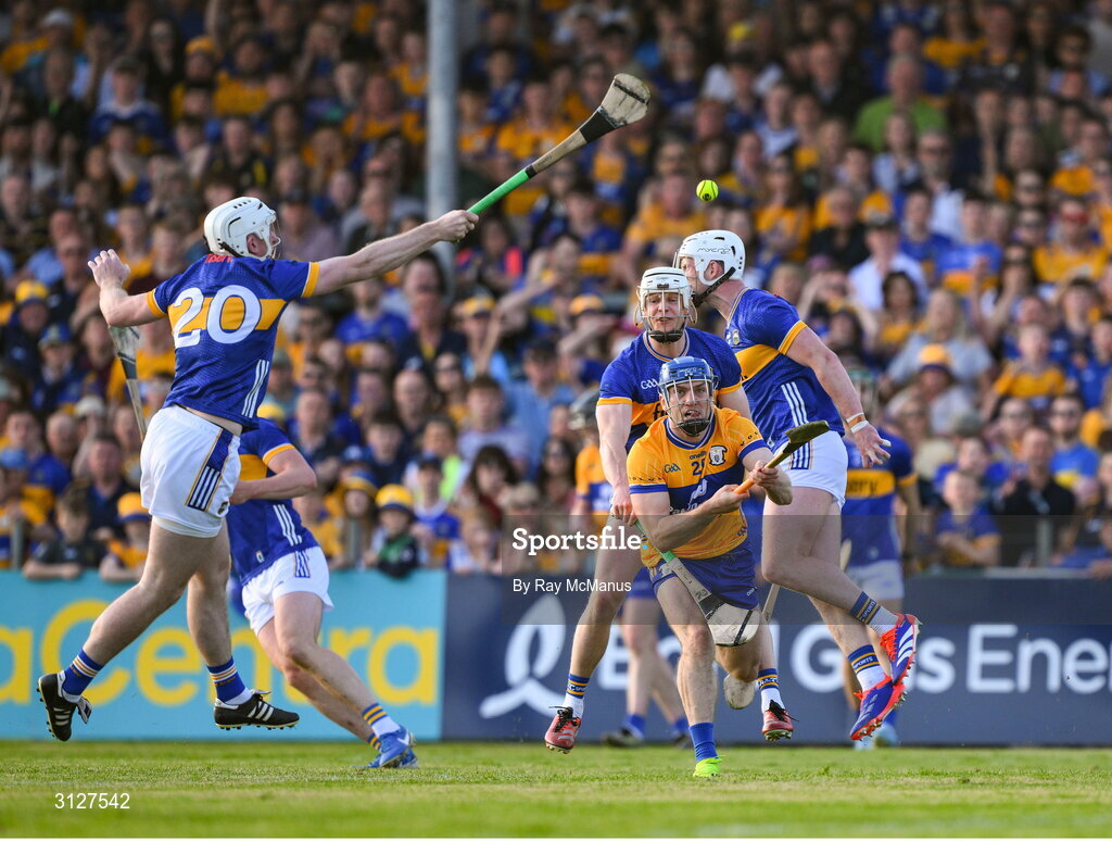 10 May 2025; Shane O Donnell of Clare passes the sliothar under pressure from Tipperary players including Peter McGarry during the Munster GAA Hurling Senior Championship Round 3 match between Clare and Tipperary at Zimmer Biomet Páirc Chíosóg in Ennis, Clare.