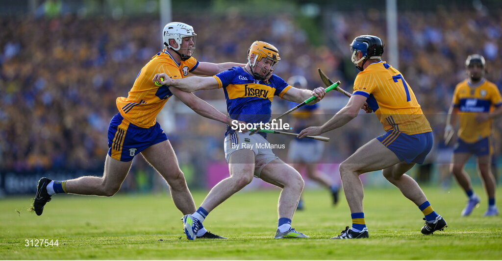 10 May 2025; Jake Morris of Tipperary is tackled by Cian Galvin and David McInerney of Clare during the Munster GAA Hurling Senior Championship Round 3 match between Clare and Tipperary at Zimmer Biomet Páirc Chíosóg in Ennis, Clare. Photo by Ray McManus/Sportsfile
