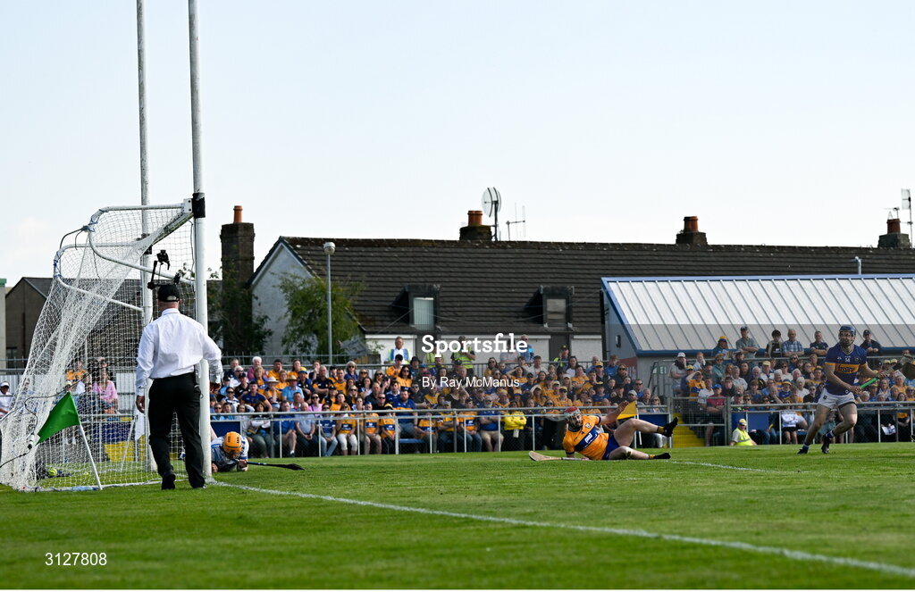 10 May 2025; Tipperary's John McGrath, right, shoots past Conor Lean of Clare and goalkeeper Eibhear Quilligan to score his 6th minute goal during the Munster GAA Hurling Senior Championship Round 3 match between Clare and Tipperary at Zimmer Biomet Páirc Chíosóg in Ennis, Clare. Photo by Ray McManus/Sportsfile