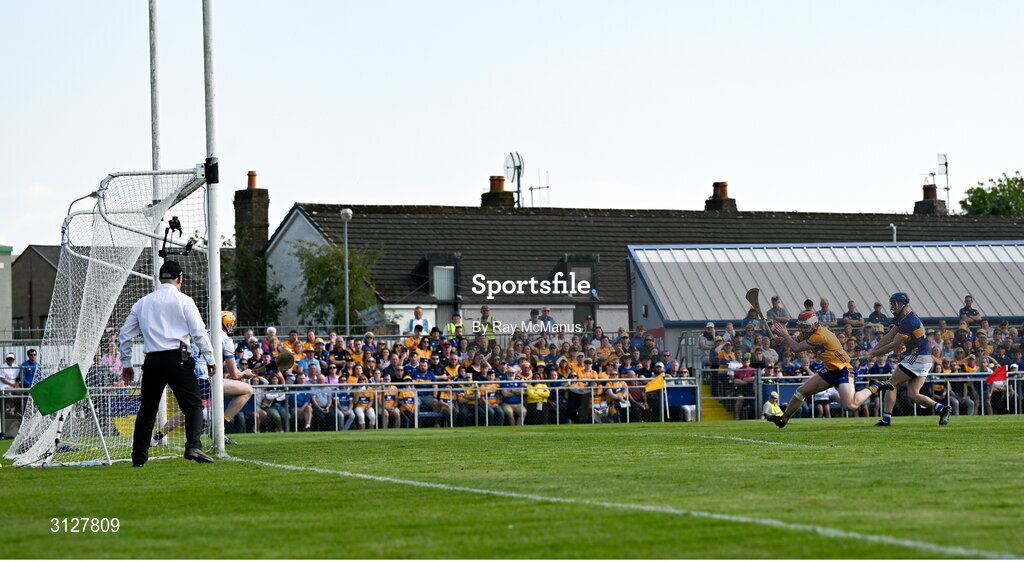 10 May 2025; Tipperary's John McGrath, right, shoots past Conor Lean of Clare and goalkeeper Eibhear Quilligan to score his 6th minute goal during the Munster GAA Hurling Senior Championship Round 3 match between Clare and Tipperary at Zimmer Biomet Páirc Chíosóg in Ennis, Clare. Photo by Ray McManus/Sportsfile