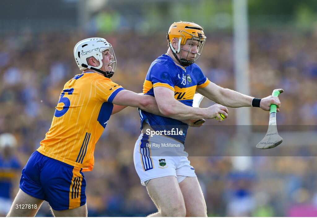 10 May 2025; Jake Morris of Tipperary is tackled by Cian Galvin of Clare during the Munster GAA Hurling Senior Championship Round 3 match between Clare and Tipperary at Zimmer Biomet Páirc Chíosóg in Ennis, Clare. Photo by Ray McManus/Sportsfile