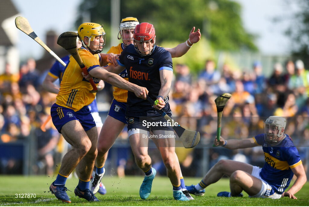 10 May 2025; Tipperary goalkeeper Rhys Shelly is tackled by Clare players, from left, Mark Rodgers and Sean Rynne during the Munster GAA Hurling Senior Championship Round 3 match between Clare and Tipperary at Zimmer Biomet Páirc Chíosóg in Ennis, Clare. Photo by John Sheridan/Sportsfile