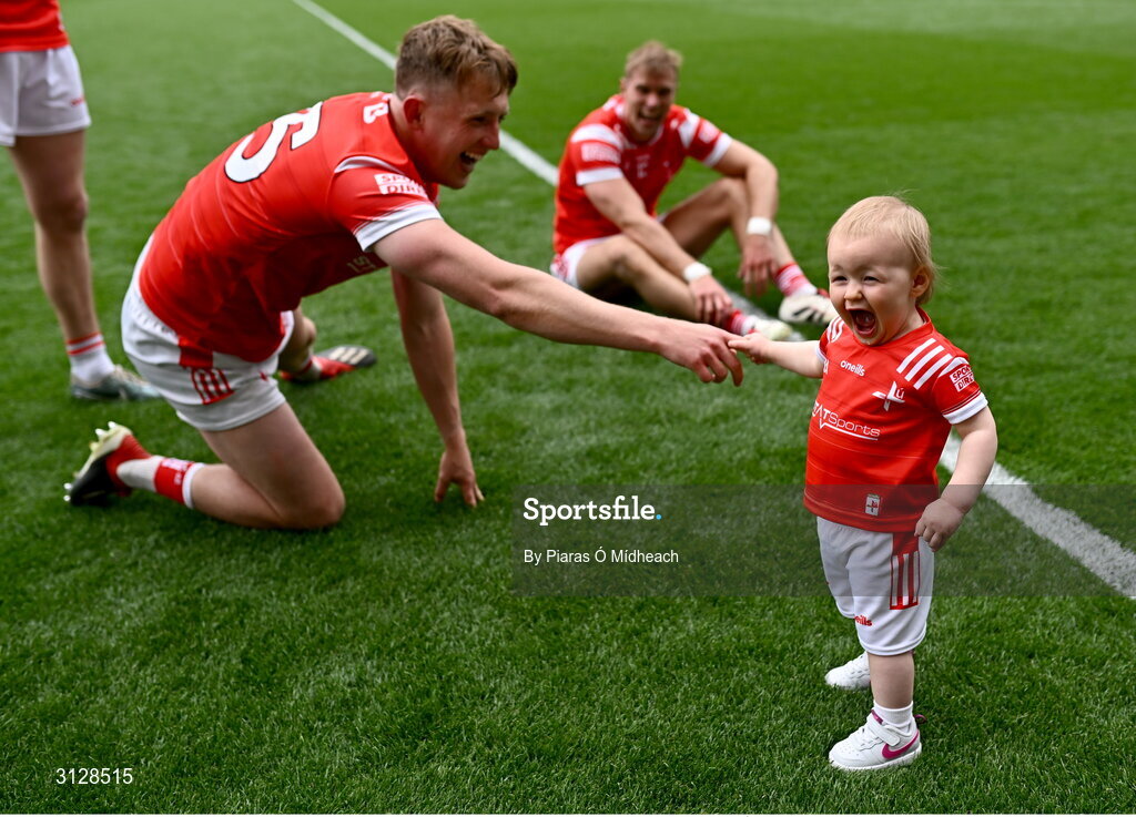 11 May 2025; Izzy Grimes, aged one, daughter of Louth footballer Conor Grimes with Ryan Burns, left, and her father Conor Grimes after the Leinster GAA Football Senior Championship final match between Louth and Meath at Croke Park in Dublin. Photo by Piaras Ó Mídheach/Sportsfile