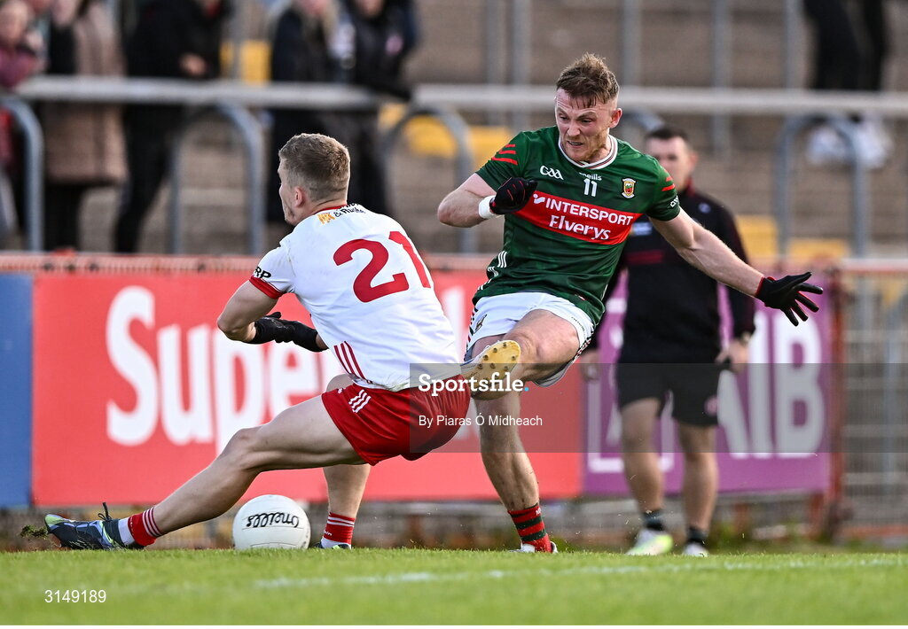 31 May 2025; Darren McHale of Mayo scores his side's first goal despite the efforts of Ben McDonnell of Tyrone during the GAA Football All-Ireland Senior Championship Round 2 match between Tyrone and Mayo at O'Neills Healy Park in Omagh, Tyrone. Photo by Piaras Ó Mídheach/Sportsfile