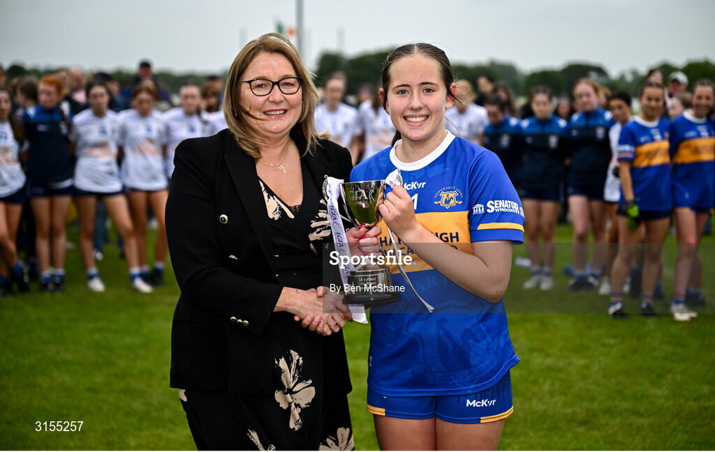 8 June 2025; Tipperary captain Farrah Madigan is presented the cup by Trina Murray, LGFA President, after the LGFA All-Ireland U14 Silver Final match between Tipperary and Cavan at Coralstown/Kinnegad GAA in Westmeath. Photo by Ben McShane/Sportsfile