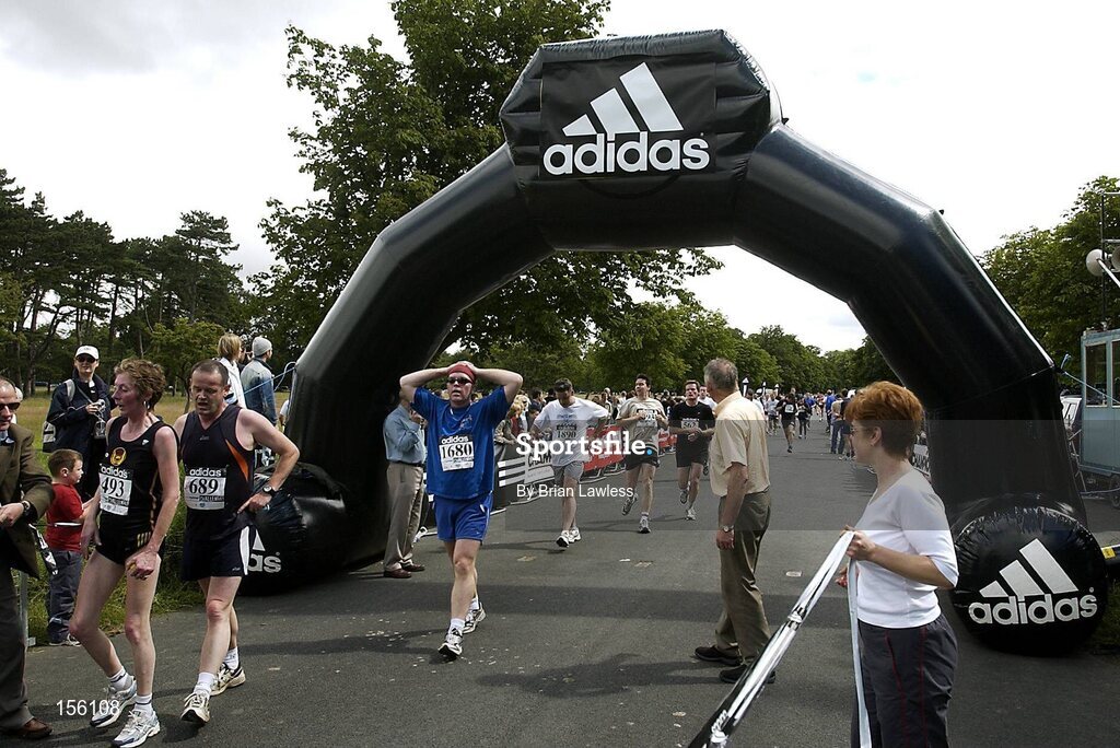 4 July 2004; Competitors make their way across the finish line during the adidas Irish Runner Challenge, Phoenix Park, Dublin. Picture credit; Brian Lawless / SPORTSFILE