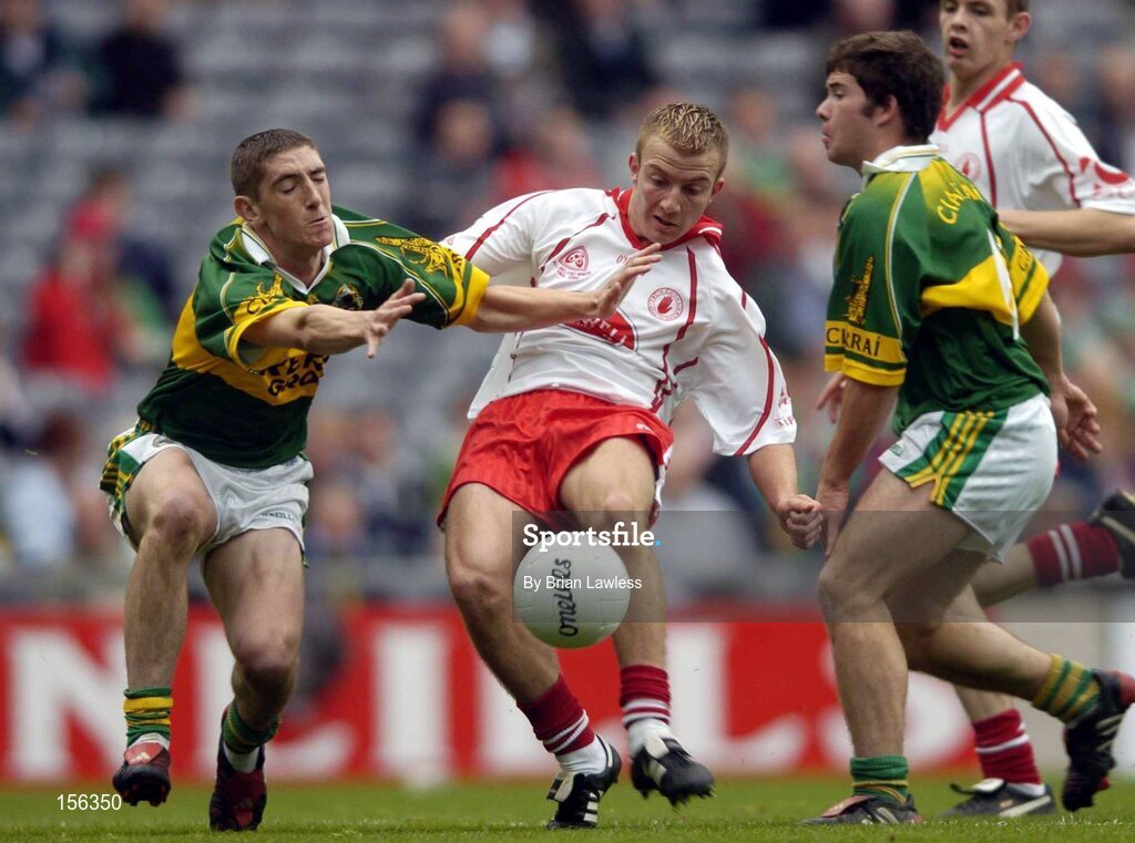 26 September 2004; Cathal O'Neill, Tyrone, in action against Killian Young, left, and Ciaran Kelliher, Kerry. All-Ireland Minor Football Championship Final, Kerry v Tyrone, Croke Park, Dublin. Picture credit; Brian Lawless / SPORTSFILE *** Local Caption *** Any photograph taken by SPORTSFILE during, or in connection with, the 2004 All-Ireland Minor Football Final which displays GAA logos or contains an image or part of an image of any GAA intellectual property, or, which contains images of a GAA player/players in their playing uniforms, may only be used for editorial and non-advertising purposes.  Use of photographs for advertising, as posters or for purchase separately is strictly prohibited unless prior written approval has been obtained from the Gaelic Athletic Association.