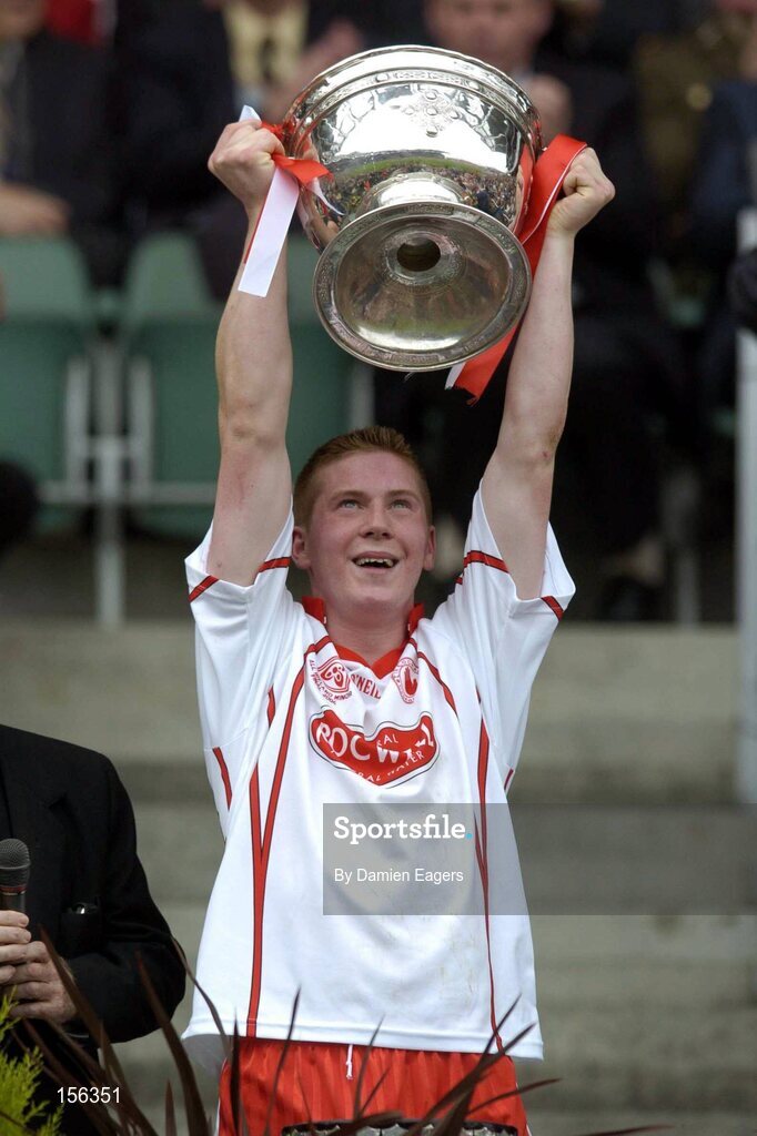 26 September 2004; Tyrone captain Marc Cunningham lifts the Tom Markham Cup after victory over Kerry. All-Ireland Minor Football Championship Final, Kerry v Tyrone, Croke Park, Dublin. Picture credit; Damien Eagers / SPORTSFILE *** Local Caption *** Any photograph taken by SPORTSFILE during, or in connection with, the 2004 All-Ireland Minor  Football Final which displays GAA logos or contains an image or part of an image of any GAA intellectual property, or, which contains images of a GAA player/players in their playing uniforms, may only be used for editorial and non-advertising purposes.  Use of photographs for advertising, as posters or for purchase separately is strictly prohibited unless prior written approval has been obtained from the Gaelic Athletic Association.