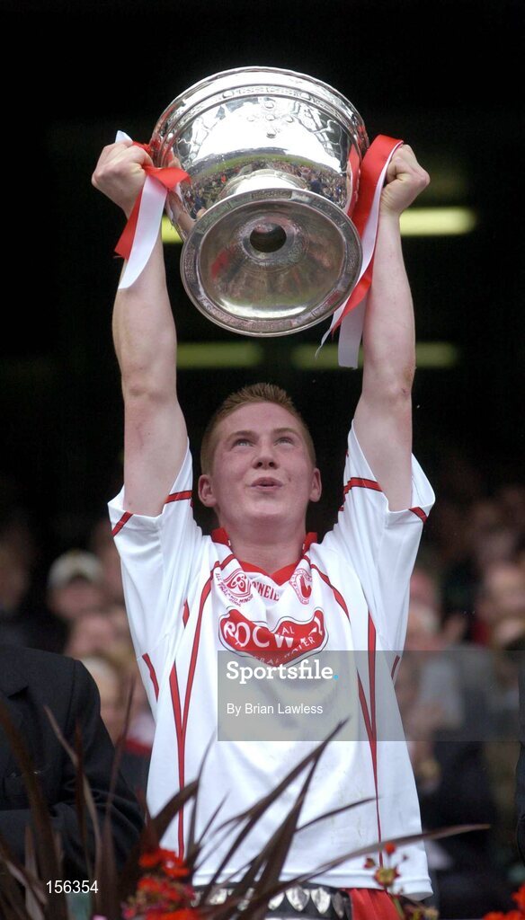 26 September 2004; Tyrone captain Marc Cunningham lifts the Tom Markham cup after victory over Kerry. All-Ireland Minor Football Championship Final, Kerry v Tyrone, Croke Park, Dublin. Picture credit; Brian Lawless / SPORTSFILE *** Local Caption *** Any photograph taken by SPORTSFILE during, or in connection with, the 2004 All-Ireland Minor Football Final which displays GAA logos or contains an image or part of an image of any GAA intellectual property, or, which contains images of a GAA player/players in their playing uniforms, may only be used for editorial and non-advertising purposes.  Use of photographs for advertising, as posters or for purchase separately is strictly prohibited unless prior written approval has been obtained from the Gaelic Athletic Association.