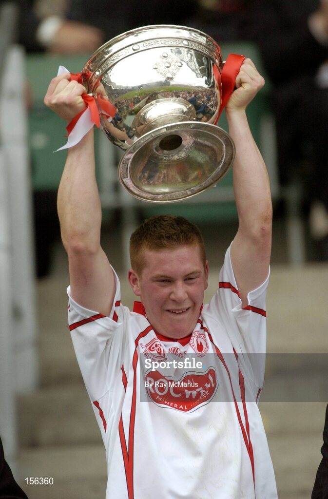 26 September 2004; Marc Cunningham, Tyrone, lifts the Cup. All-Ireland Minor Football Championship Final, Kerry v Tyrone, Croke Park, Dublin. Picture credit; Ray McManus / SPORTSFILE *** Local Caption *** Any photograph taken by SPORTSFILE during, or in connection with, the 2004 All-Ireland Minor Football Final which displays GAA logos or contains an image or part of an image of any GAA intellectual property, or, which contains images of a GAA player/players in their playing uniforms, may only be used for editorial and non-advertising purposes.  Use of photographs for advertising, as posters or for purchase separately is strictly prohibited unless prior written approval has been obtained from the Gaelic Athletic Association.