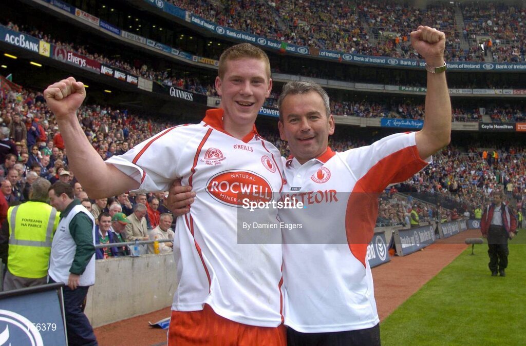 26 September 2004; Tyrone captain Marc Cunningham, left, and Tyrone manager Liam Donnelly celebrate after victory over Kerry. All-Ireland Minor Football Championship Final, Kerry v Tyrone, Croke Park, Dublin. Picture credit; Damien Eagers / SPORTSFILE *** Local Caption *** Any photograph taken by SPORTSFILE during, or in connection with, the 2004 All-Ireland Minor  Football Final which displays GAA logos or contains an image or part of an image of any GAA intellectual property, or, which contains images of a GAA player/players in their playing uniforms, may only be used for editorial and non-advertising purposes.  Use of photographs for advertising, as posters or for purchase separately is strictly prohibited unless prior written approval has been obtained from the Gaelic Athletic Association.