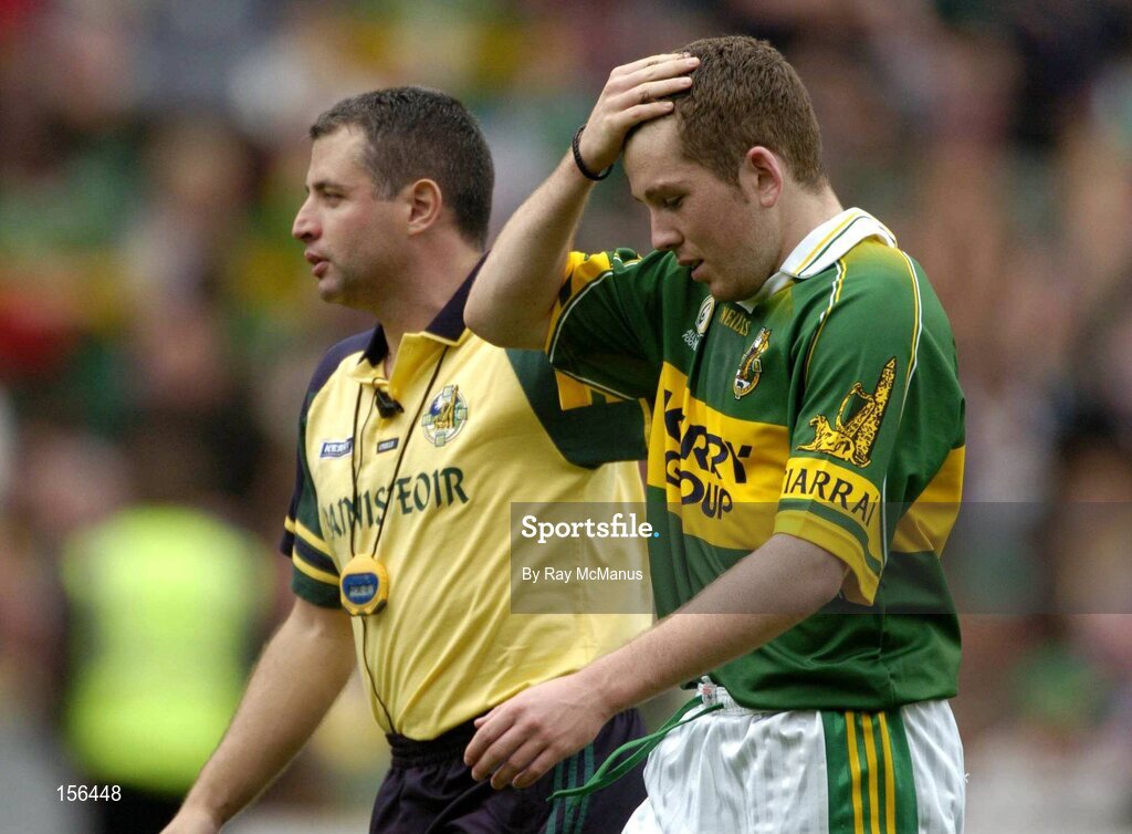 26 September 2004; Luke Quinn, Kerry, with team manager Sean Geaney after the game. All-Ireland Minor Football Championship Final, Kerry v Tyrone, Croke Park, Dublin. Picture credit; Ray McManus / SPORTSFILE *** Local Caption *** Any photograph taken by SPORTSFILE during, or in connection with, the 2004 All-Ireland Minor Football Final which displays GAA logos or contains an image or part of an image of any GAA intellectual property, or, which contains images of a GAA player/players in their playing uniforms, may only be used for editorial and non-advertising purposes.  Use of photographs for advertising, as posters or for purchase separately is strictly prohibited unless prior written approval has been obtained from the Gaelic Athletic Association.