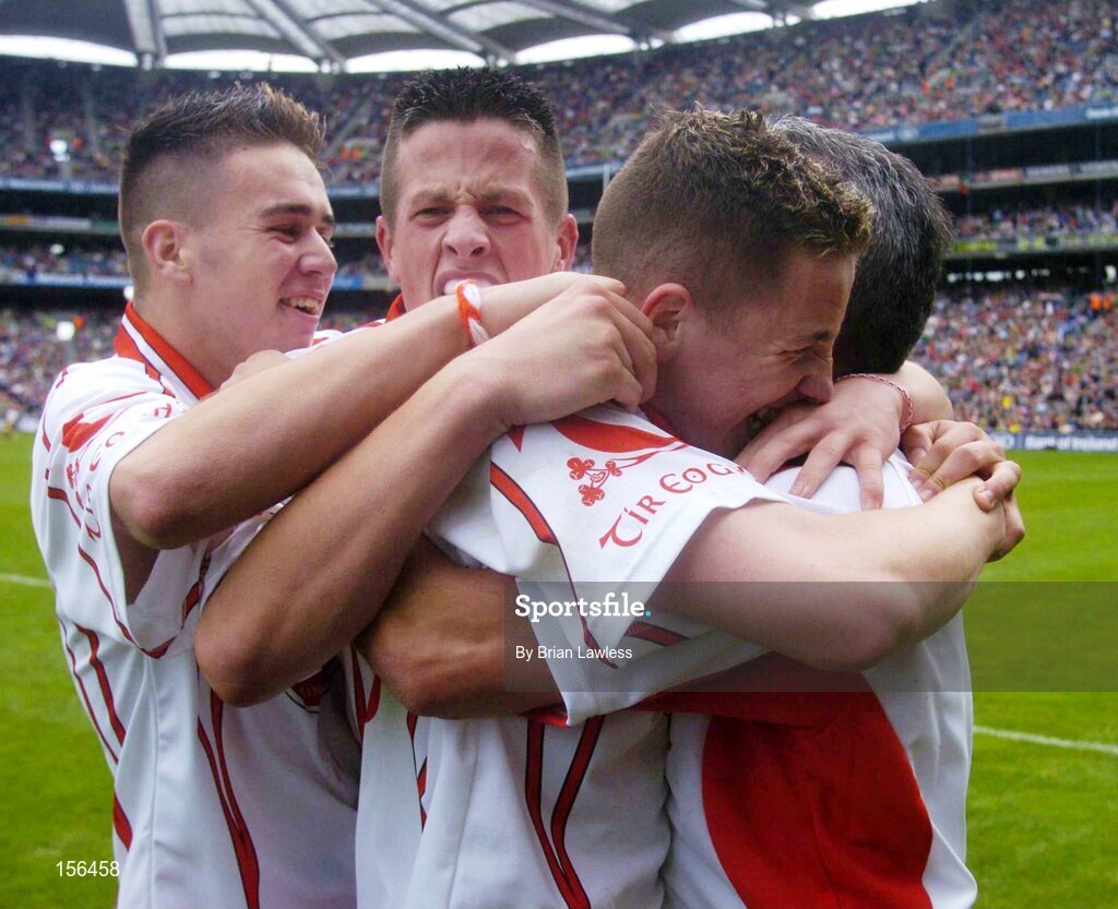 26 September 2004; Tyrone players, from left, Niall Kerr, Shane O'Hagan and Gareth Devlin celebrate with manager Liam Doyle after victory in the final. All-Ireland Minor Football Championship Final, Kerry v Tyrone, Croke Park, Dublin. Picture credit; Brian Lawless / SPORTSFILE *** Local Caption *** Any photograph taken by SPORTSFILE during, or in connection with, the 2004 All-Ireland Minor Football Final which displays GAA logos or contains an image or part of an image of any GAA intellectual property, or, which contains images of a GAA player/players in their playing uniforms, may only be used for editorial and non-advertising purposes.  Use of photographs for advertising, as posters or for purchase separately is strictly prohibited unless prior written approval has been obtained from the Gaelic Athletic Association.