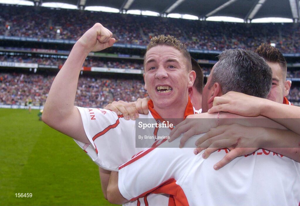 26 September 2004; Gareth Devlin, Tyrone, celebrates with manager Liam Doyle after victory over Kerry. All-Ireland Minor Football Championship Final, Kerry v Tyrone, Croke Park, Dublin. Picture credit; Brian Lawless / SPORTSFILE *** Local Caption *** Any photograph taken by SPORTSFILE during, or in connection with, the 2004 All-Ireland Minor Football Final which displays GAA logos or contains an image or part of an image of any GAA intellectual property, or, which contains images of a GAA player/players in their playing uniforms, may only be used for editorial and non-advertising purposes.  Use of photographs for advertising, as posters or for purchase separately is strictly prohibited unless prior written approval has been obtained from the Gaelic Athletic Association.
