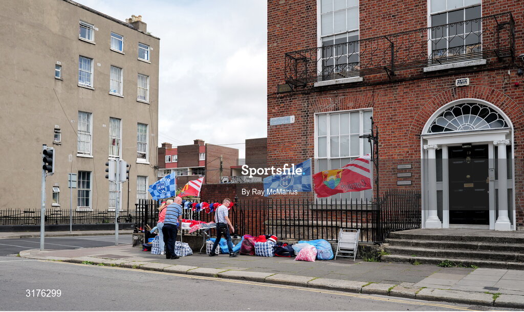 5 July 2025; Sellers of 'hats, flags and colours of the game' prepare their stand on Mountjoy Square in advance of the GAA Hurling All-Ireland Senior Championship semi-final match between Cork and Dublin at Croke Park in Dublin. Photo by Ray McManus/Sportsfile