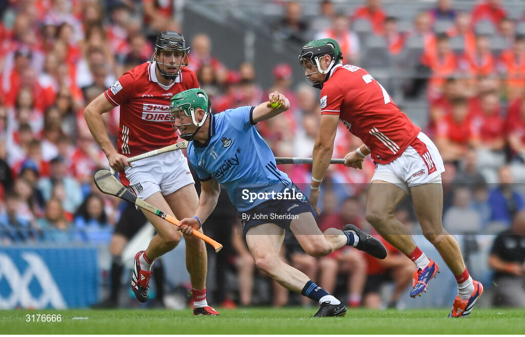 5 July 2025; Fergal Whitely of Dublin in action against Cork players, from left, Robert Downey and Mark Coleman during the GAA Hurling All-Ireland Senior Championship semi-final match between Cork and Dublin at Croke Park in Dublin. Photo by John Sheridan/Sportsfile