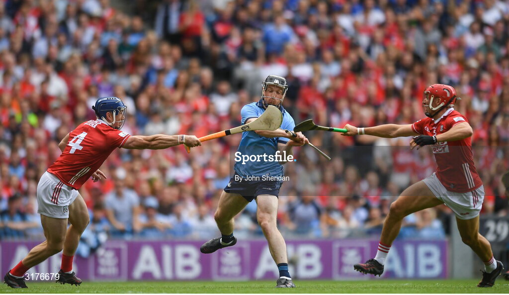 5 July 2025; Cian O'Sullivan of Dublin is tackled by Cork players, from left, Seán O'Donoghue and Ciarán Joyce during the GAA Hurling All-Ireland Senior Championship semi-final match between Cork and Dublin at Croke Park in Dublin. Photo by John Sheridan/Sportsfile