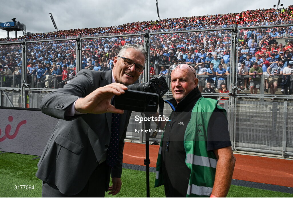 5 July 2025; Irish Examiner photographer Eddie O'Hare, who retired after today's game having served the paper for more than 47 years, is photographed with the Uachtarán Chumann Lúthchleas Gael Jarlath Burns before the GAA Hurling All-Ireland Senior Championship semi-final match between Cork and Dublin at Croke Park in Dublin. Photo by Ray McManus/Sportsfile