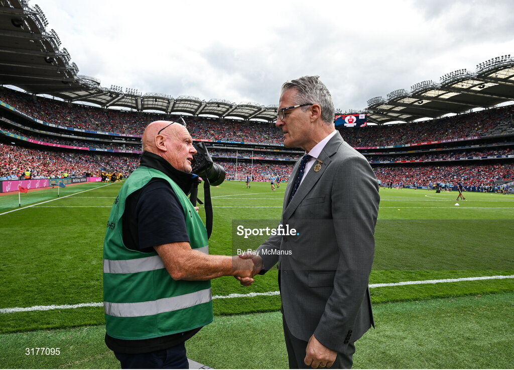 5 July 2025; Irish Examiner photographer Eddie O'Hare, who retired after today's game having served the paper for more than 47 years, is photographed with the Uachtarán Chumann Lúthchleas Gael Jarlath Burns before the GAA Hurling All-Ireland Senior Championship semi-final match between Cork and Dublin at Croke Park in Dublin. Photo by Ray McManus/Sportsfile