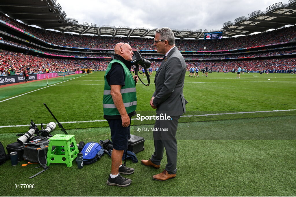 5 July 2025; Irish Examiner photographer Eddie O'Hare, who retired after today's game having served the paper for more than 47 years, is photographed with the Uachtarán Chumann Lúthchleas Gael Jarlath Burns before the GAA Hurling All-Ireland Senior Championship semi-final match between Cork and Dublin at Croke Park in Dublin. Photo by Ray McManus/Sportsfile