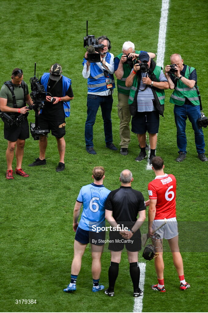 5 July 2025; Referee Johnny Murphy stands with Dublin captian Conor Burke and Cork captain Robert Downey before the GAA Hurling All-Ireland Senior Championship semi-final match between Cork and Dublin at Croke Park in Dublin. Photo by Stephen McCarthy/Sportsfile