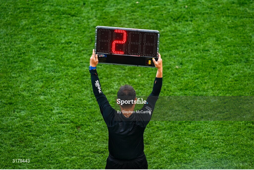5 July 2025; A sideline official holds up a board indicating two minutes of injury time to be played at the end of the first half during the GAA Hurling All-Ireland Senior Championship semi-final match between Cork and Dublin at Croke Park in Dublin. Photo by Stephen McCarthy/Sportsfile