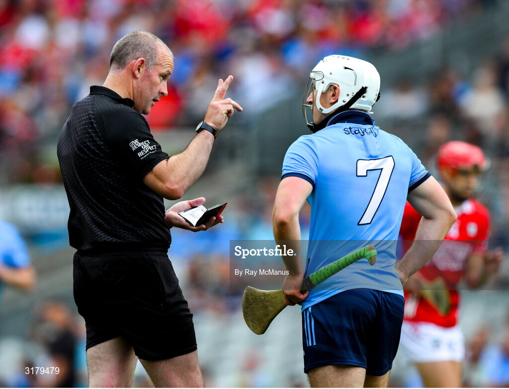 5 July 2025; Referee Johnny Murphy speaks to Andy Dunphy of Dublin before he issued a yellow card during the GAA Hurling All-Ireland Senior Championship semi-final match between Cork and Dublin at Croke Park in Dublin. Photo by Ray McManus/Sportsfile